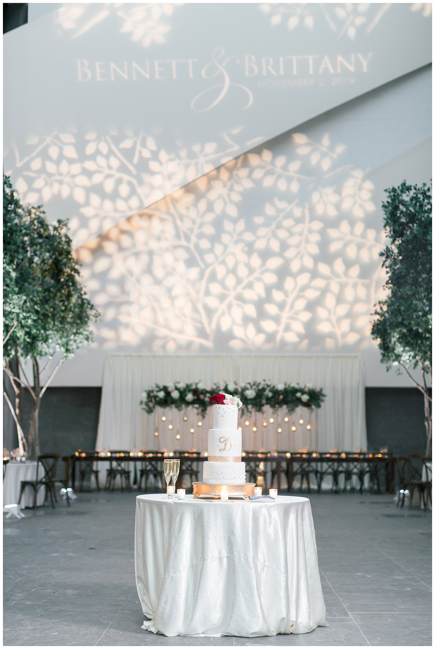 Floral and greenery wedding reception decor at Ritz Carlton Charlotte with monogram light